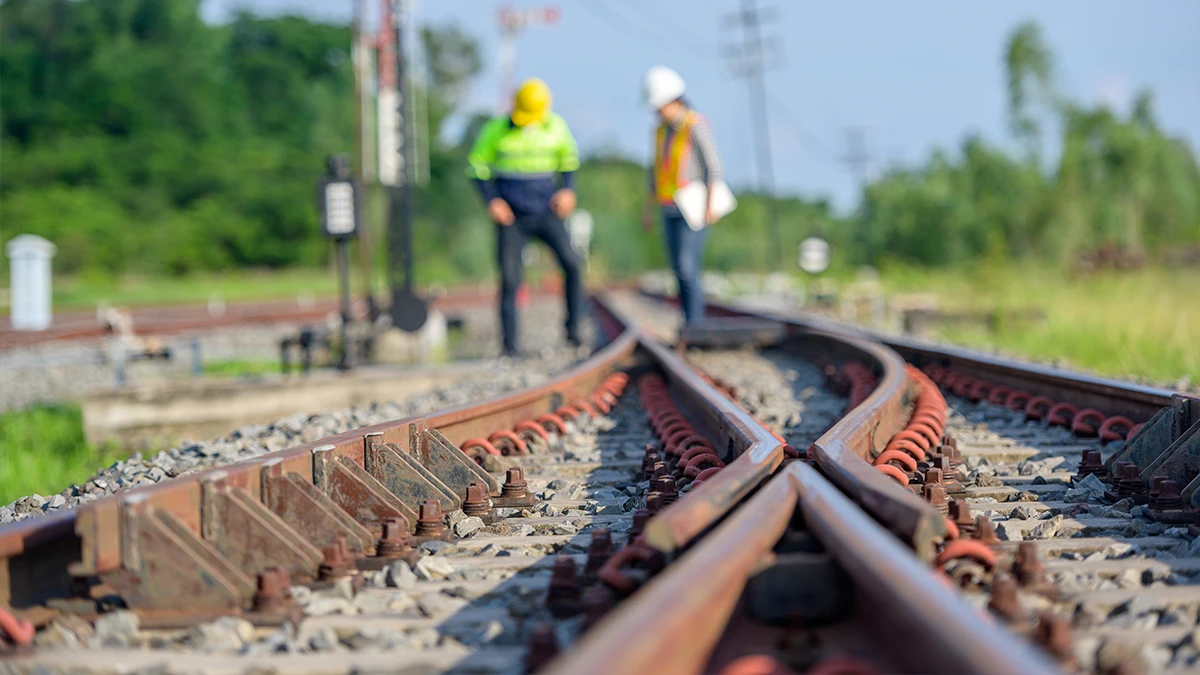 Railroad workers inspect a railroad.